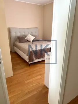 View from the hallway into a bedroom with a double bed and hardwood flooring. - image 7