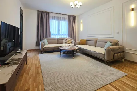 Comfortable living room with two sofas, a coffee table, a TV, and parquet flooring. - image 20