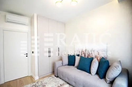 Living room with sofa, built-in wardrobe and air conditioning.
