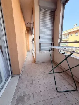 Spacious tiled terrace with a clothes drying rack and window shutters. - image 11