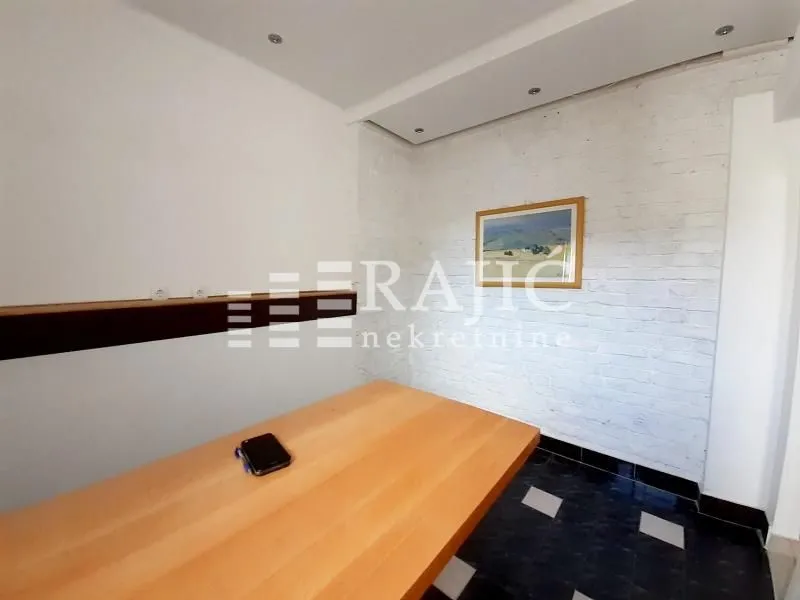 Living room with a dining table and white walls.