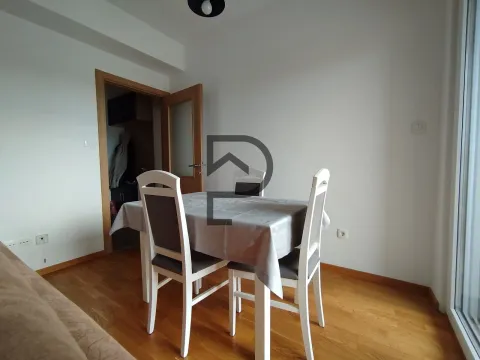 Dining area with a table and white chairs in a bright interior. - image 4