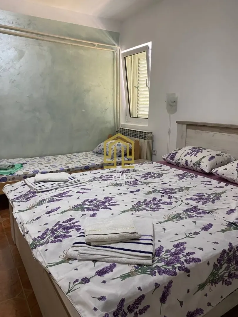 Bedroom with beds and lavender-patterned bedding.