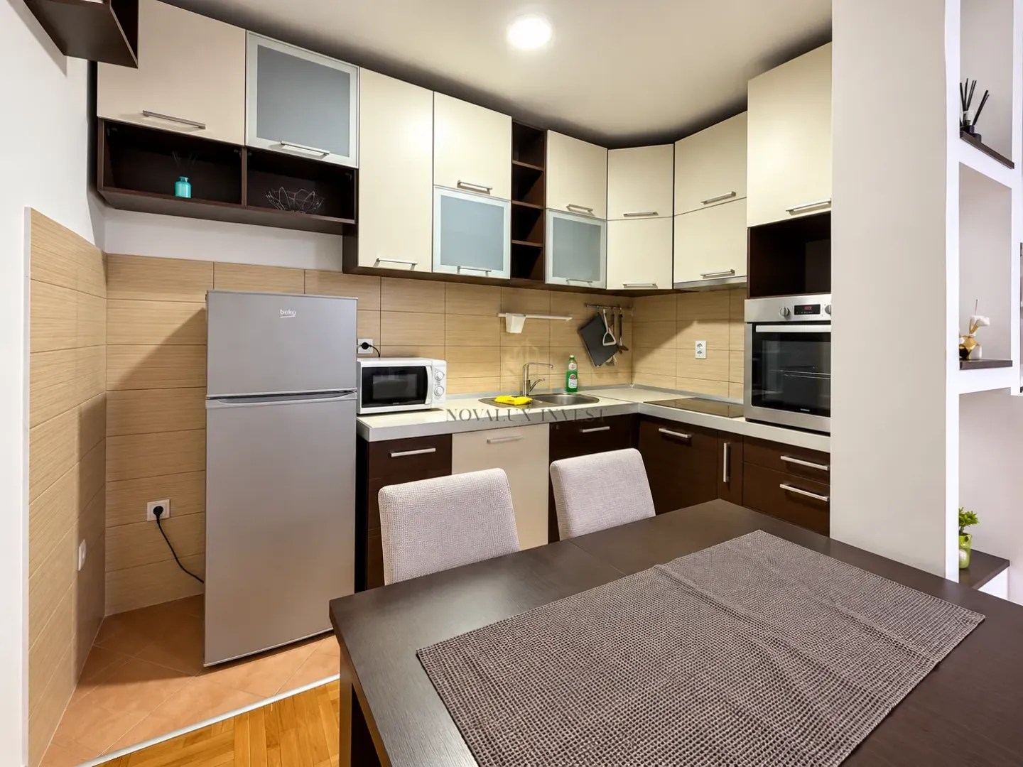 Modern kitchen with a dining table and built-in appliances.