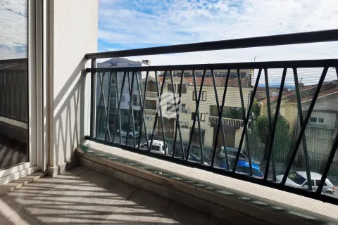 Small balcony with a metal railing and a street view. - image 13