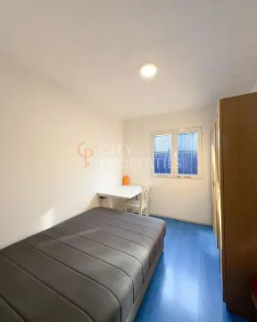 Furnished bedroom with a bed, desk, and wardrobe. - image 5