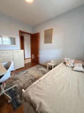 Furnished bedroom with a bed, desk, and wardrobe. - image 11