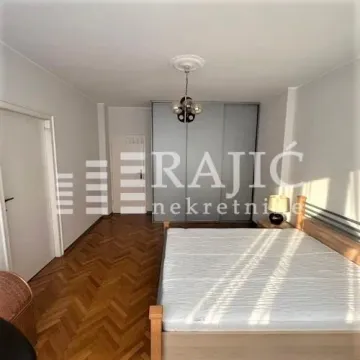 Spacious bedroom with a double bed and a fitted wardrobe. - image 6