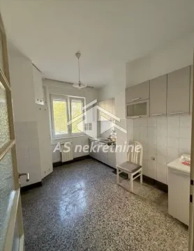 Small kitchen with white cabinets and a window. - image 4