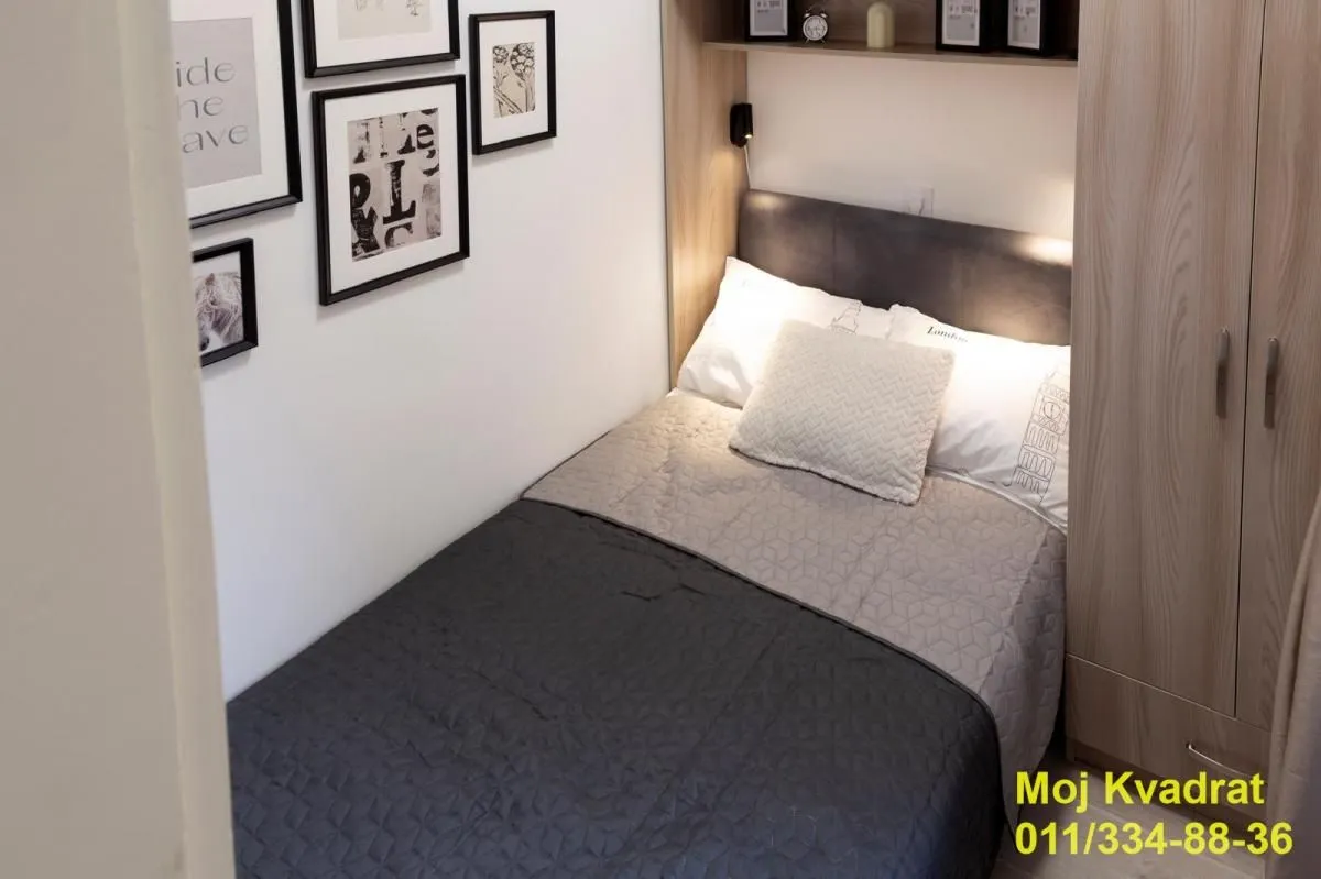 Small bedroom with a bed and wardrobe.