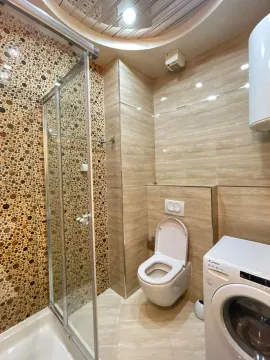 Moderno opremljeno kupatilo sa tuš kabinom, WC šoljom i veš mašinom. - image 23