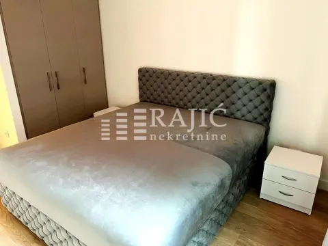 Furnished bedroom with a double bed and fitted wardrobe. - image 6