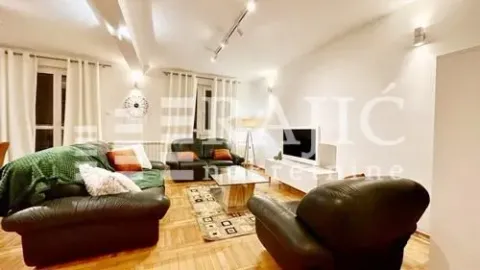 Spacious living room with a sofa set and a TV. - image 6