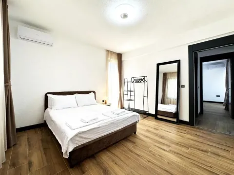 Spacious bedroom with a double bed, air conditioning, and a view of the hallway. - image 9