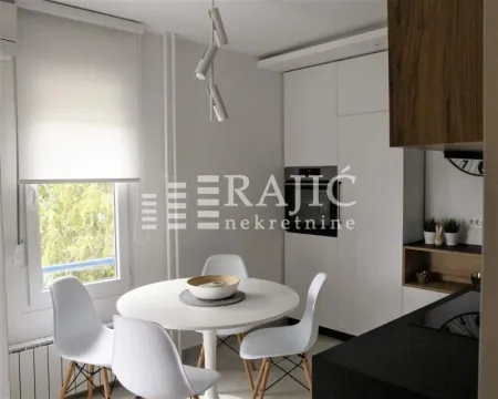 Modern kitchen with a dining table and white chairs. - image 5