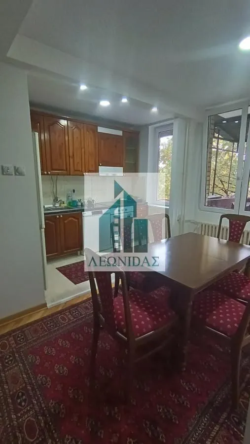 Kitchen with dining area and wooden cabinets.