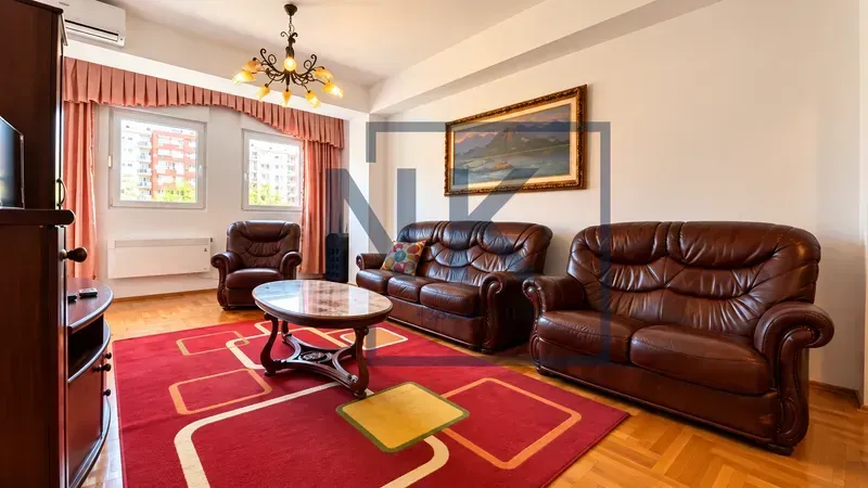 Living room with seating furniture and wooden furnishings.