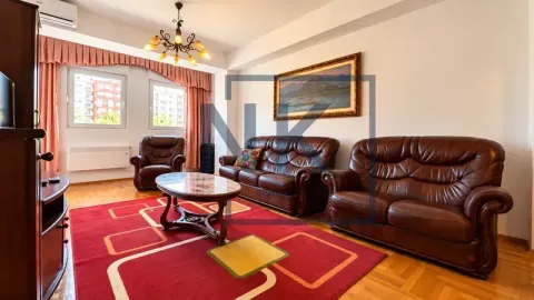 Living room with seating furniture and wooden furnishings. - image 2
