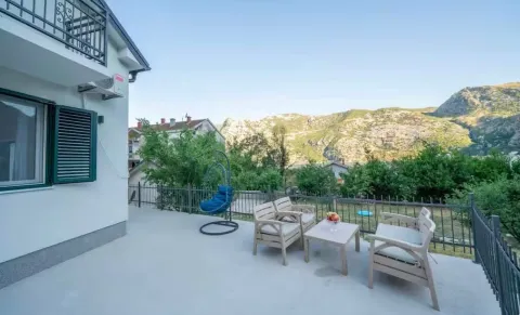 Spacious terrace with outdoor furniture and mountain views. - image 14
