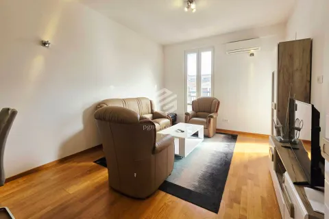 Living room with seating furniture, a coffee table and a television. - image 18