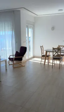 Bright living room with dining area and access to the terrace. - image 4