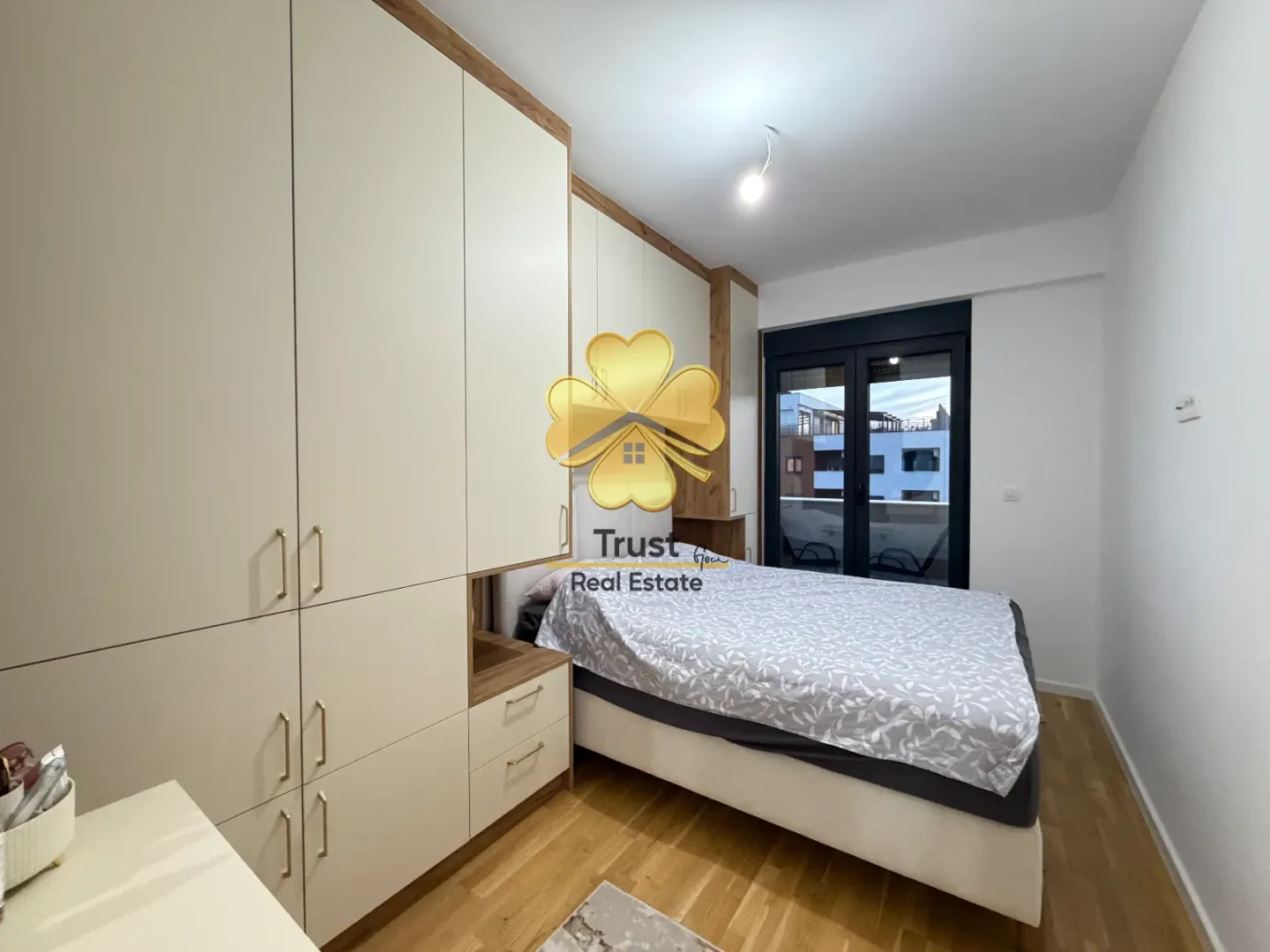 Furnished bedroom with a built-in wardrobe and a double bed.
