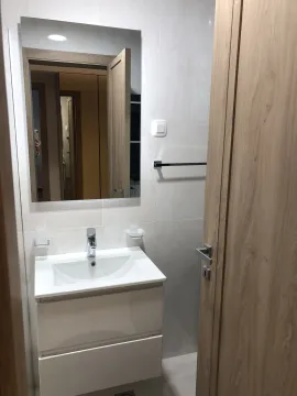 Bright bathroom with a modern sink and a large mirror. - image 16
