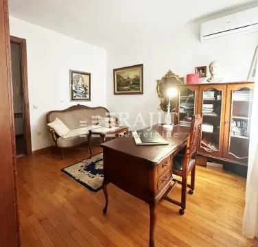 Living room with a desk and classical furniture. - image 2