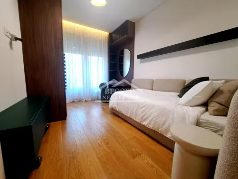 Modern bedroom with a bed, wooden flooring, and a built-in wardrobe. - image 14