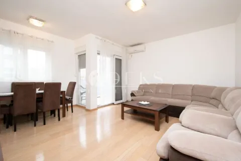 Living room with a sofa set and dining area. - image 2