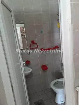 Smaller tiled bathroom with a toilet and washbasin. - image 10
