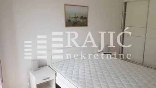 Furnished bedroom with a double bed and built-in wardrobe.