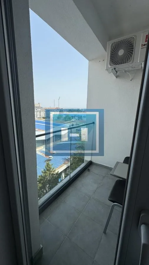 View of the surroundings from a smaller balcony with a glass railing.