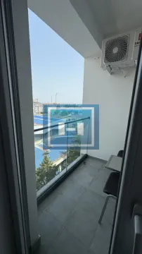 View of the surroundings from a smaller balcony with a glass railing. - image 17