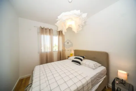 Furnished bedroom with a double bed, window, and chandelier. - image 7