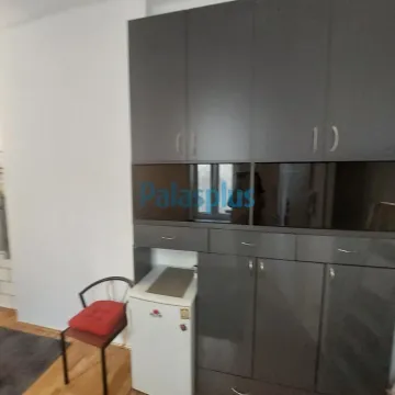 Small kitchen with dark cabinets and a white refrigerator. - image 2