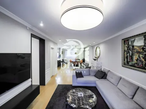 Spacious living room with a sectional sofa, TV, and a view towards the dining area. - image 18