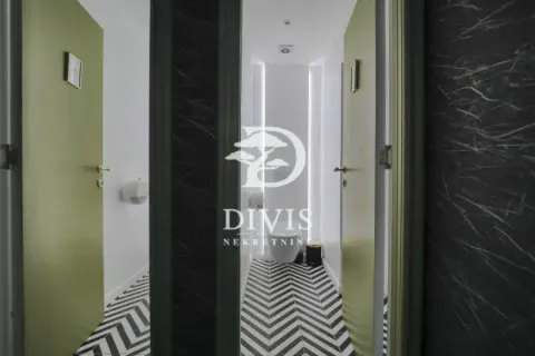Modern restrooms with black and white patterned flooring and green doors. - image 18