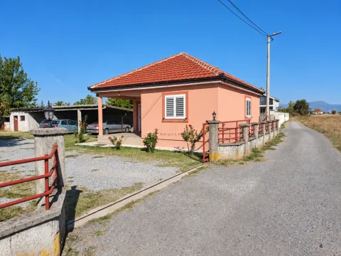 View of a single-story house with an orange facade and a yard. - image 2