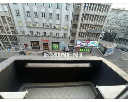 View from the balcony towards the city street and surrounding buildings. - image 18