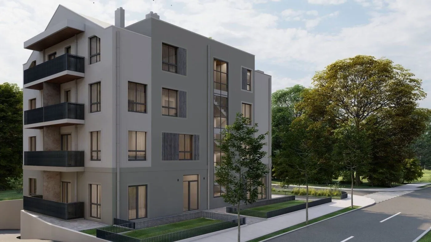 Exterior view of a modern residential building with balconies and a landscaped yard.