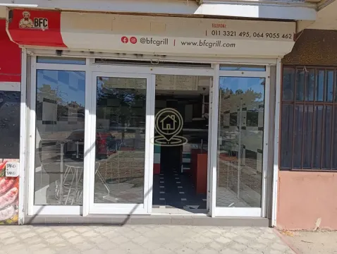 View of the entrance to the commercial space with a glass storefront. - image 2
