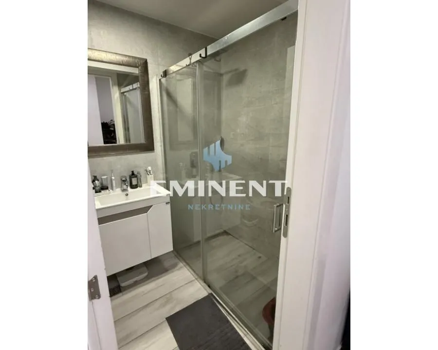 Bathroom with a walk-in shower and vanity sink.