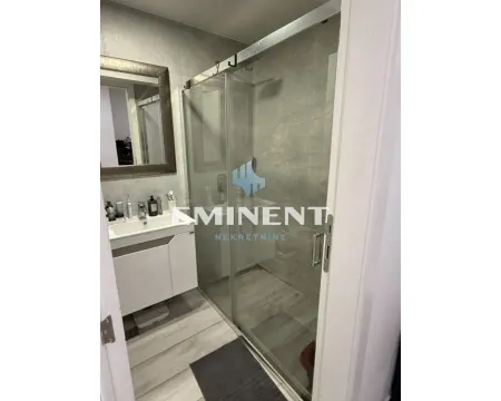 Bathroom with a walk-in shower and vanity sink. - image 12