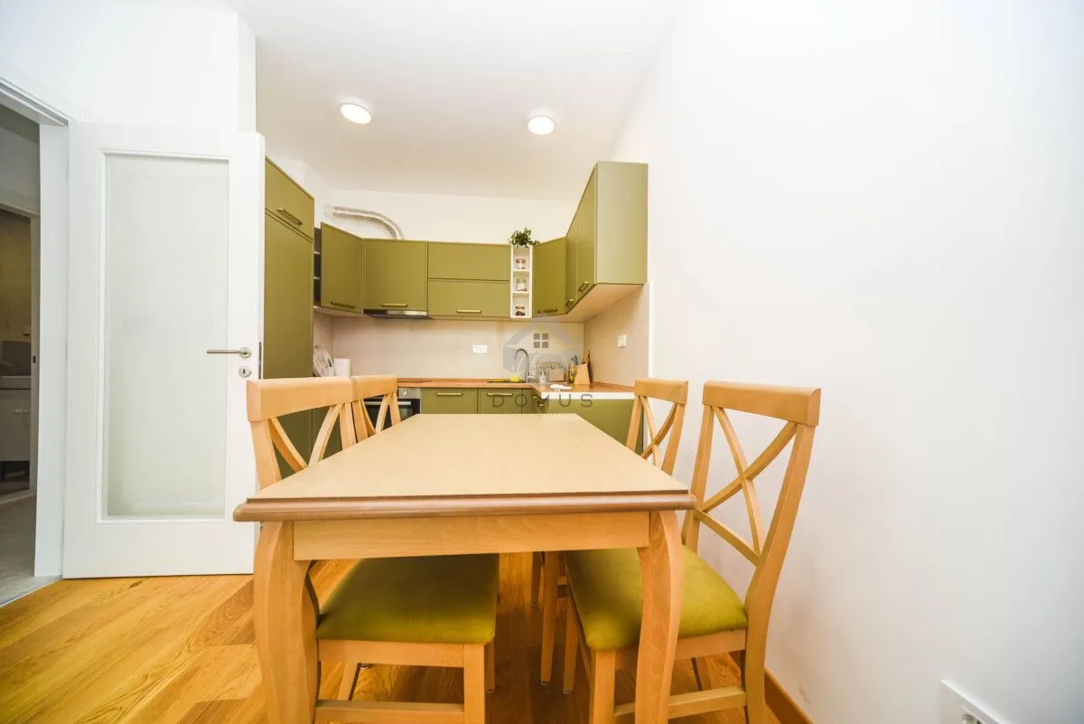 Kitchen with a dining table and wooden chairs.