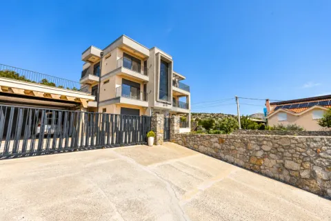 Exterior view of a modern multi-story house with a yard and fence. - image 7