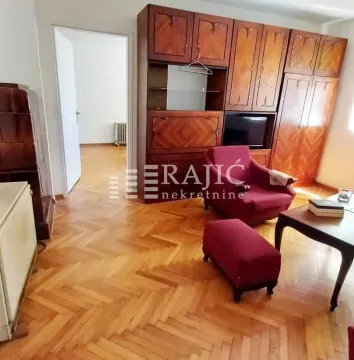 Living room with wooden furniture and parquet flooring. - image 5