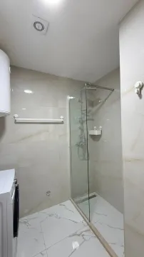 Moderne kupatilo sa tuš kabinom obloženo svijetlim pločicama. - image 10