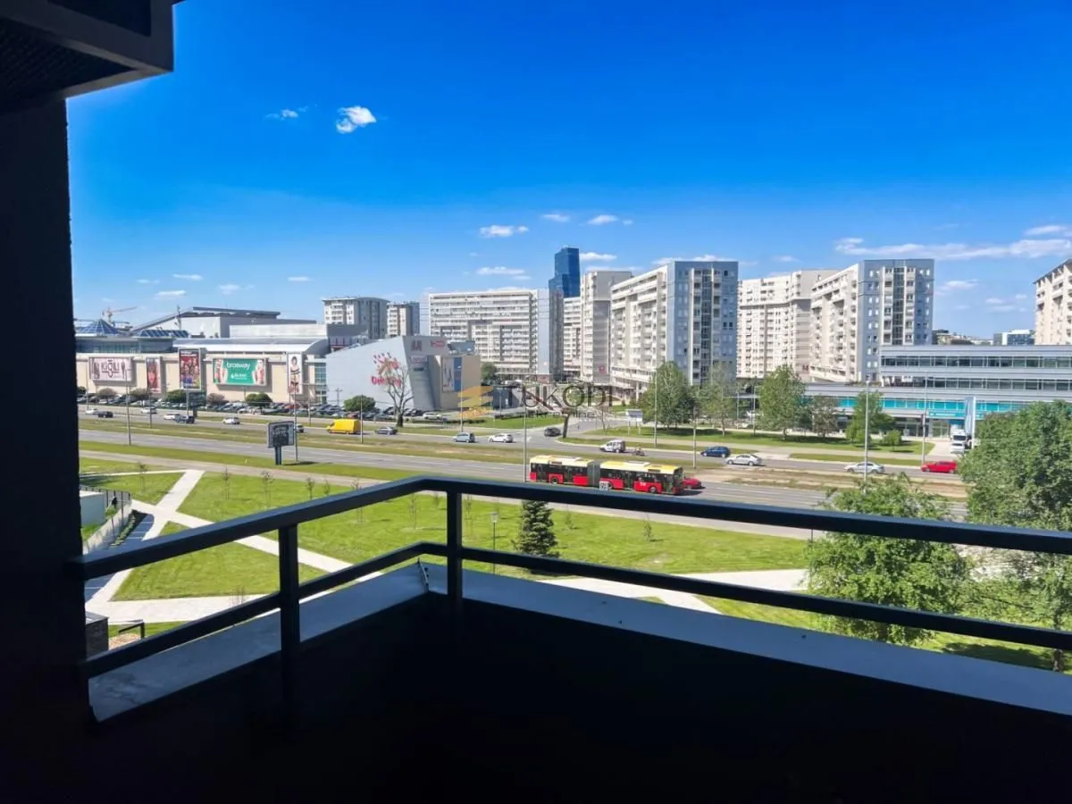View from the balcony overlooking the city street and surrounding buildings.