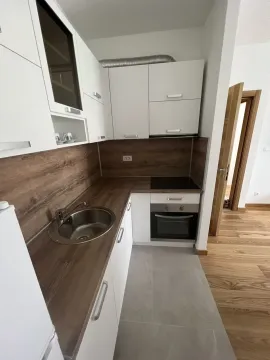 Bright and modern kitchen with white cabinets and a wooden countertop. - image 6